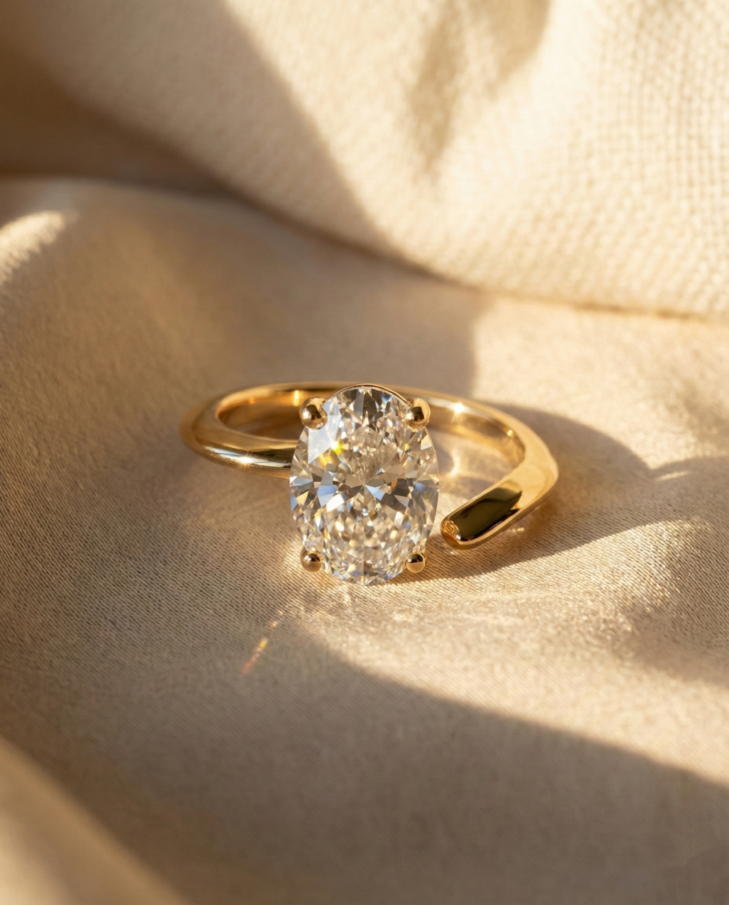 2 carat oval cut moissanite ring featuring unique open shank vine design on beige silk