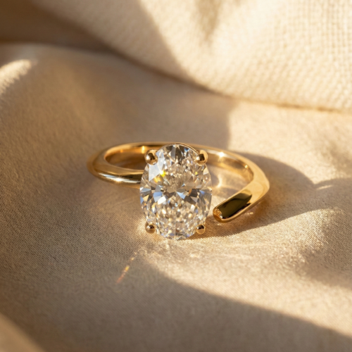 2 carat oval cut moissanite ring featuring unique open shank vine design on beige silk